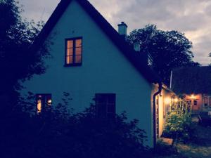 奇维克Gladeholm的夜晚窗户上灯亮的蓝色房子