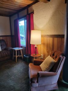 LeonLittle River Inn Motel的客厅配有椅子和灯