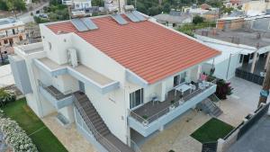 杰拉尼Galini Villas的享有白色房子顶部的橙色屋顶景色