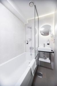 塔林Rija Old Town Hotel的白色的浴室设有浴缸和水槽。