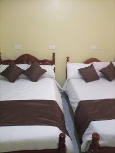 波特尔堡Legend Executive Suites的两张睡床彼此相邻,位于一个房间里