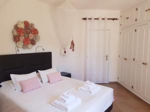 法鲁Monte-Bougainvillea的卧室配有白色床和毛巾