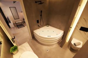 雅典K58 Luxury Apartment Monastiraki Metro Station Acropolis Jacuzzi的带浴缸和卫生间的浴室。