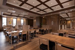 米子市Hotel Route-Inn Yonago的用餐室配有木桌和椅子