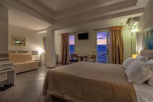 萨索斯Hotel Lido Thassos的一间卧室设有一张床和一间客厅。
