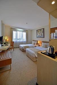 万隆万隆格兰德塞拉圣蒂布德酒店的酒店客房配有两张床和一张书桌