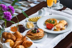 塔什干ATECA Hotel Suites Tashkent的餐桌,包括糕点和其他早餐食品