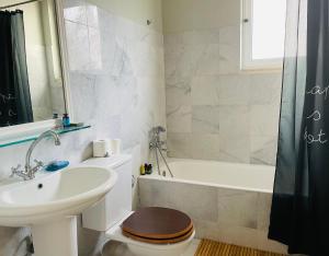 扎哈罗Rex Hotel - Bebeka's的浴室配有盥洗盆、卫生间和浴缸。