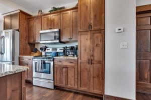布兰森Rockwood Lake Lodge home的厨房配有木制橱柜和炉灶烤箱。