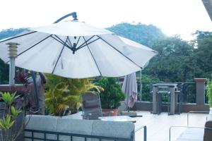 雅温得Residence MASSOU的露台顶部的白色遮阳伞
