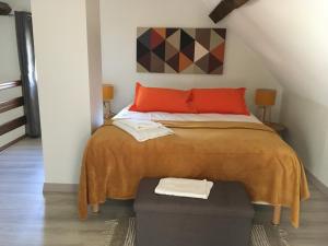 Chaumes-en-BrieLa Maison d'Emilie - Chambres d'hôtes的一间卧室配有一张带红色枕头的大床