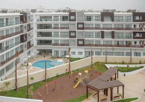 阿加迪尔Zephyr Agadir的公寓大楼前方设有游乐场