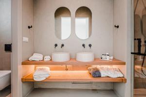 克洛瓦斯Amarelo Suites的浴室设有2个水槽和2面镜子