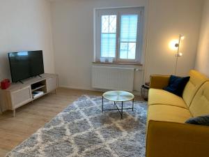 梅尔斯堡Ferienwohnungen Bohner/ Wohnung Katharina的客厅设有黄色沙发和电视