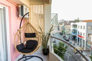 普雷韦扎City Vibes apartment Preveza的市景阳台的藤椅
