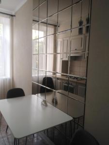 尼古拉耶夫2-комнатная квартира на Соборной的一间厨房,里面配有白色的桌子和椅子