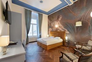 格拉茨Boutique Hotel Dom - Rooms & Suites的卧室配有一张床,墙上挂有绘画作品