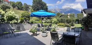 布莱德威斯纳公寓酒店的一个带桌椅的庭院和蓝伞