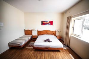 马尔萨斯卡拉森西酒店的一间卧室设有两张床和窗户。