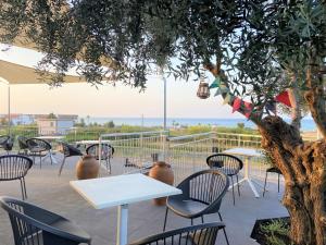 曼达托里乔码头Egò Marine的庭院配有桌椅和一棵树