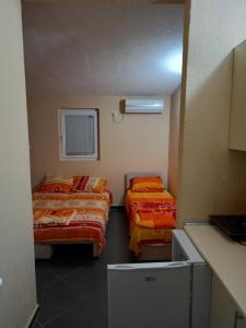 安吉MD Apartmani Canj的客房设有两张床和窗户。