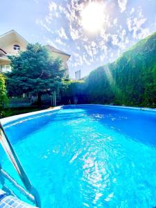 塔什干Ridon Lux Hotel的一座房子前面的蓝色水池