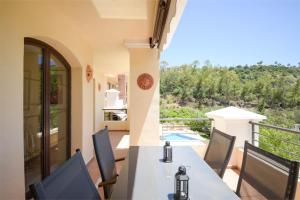 贝纳阿维斯Los Arqueros Las Jacarandas的阳台享有房屋的景致,配有桌椅