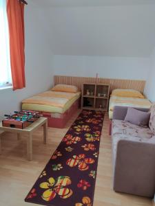 博兹达尔Apartmány u Torína的客厅配有沙发、床和地毯。