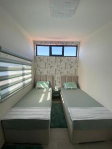 克拉西奇Martin Lux Apartment的带2扇窗户的客房内的2张床