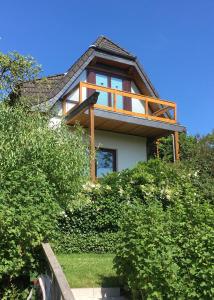 基尔Ferienwohnung Smutje的树丛顶部带阳台的房子