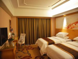 宣州区维也纳国际酒店安徽宣城花园店的酒店客房设有两张床和电视。