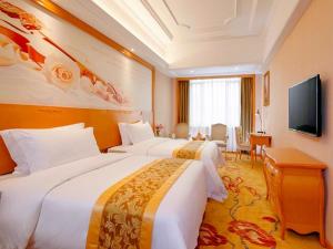 广州维也纳国际酒店广州机场新市店的酒店客房设有两张床和一台平面电视。