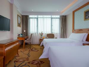 泉州维也纳酒店 (泉州西湖店)的酒店客房设有两张床和一台平面电视。