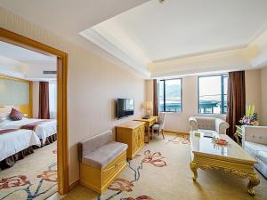 桂林维也纳酒店桂林万福广场店的大型酒店客房设有床和电视。