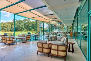 马洛皇冠假日马洛酒店的餐厅设有玻璃墙和桌椅