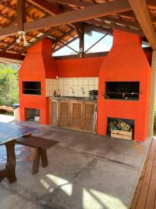 弗洛里亚诺波利斯Ilha Náutica的室外厨房设有橙色墙壁和桌子