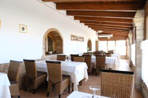 Montalbano IonicoMasseria Crocco的一间设有白色桌椅的用餐室