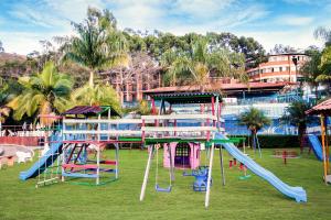 波苏斯-迪卡尔达斯Hotel Vilage Inn All Inclusive Poços de Caldas的公园设有带滑梯和滑梯的游乐场