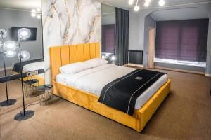 文尼察RICH Boutique-Hotel的一间卧室配有一张大床和一张书桌