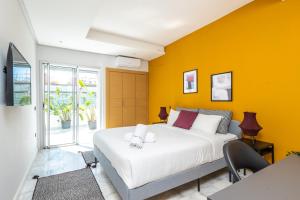 拉巴特Stayhere Rabat - Agdal 2 - Classic Residence的一间卧室设有一张大床和黄色的墙壁