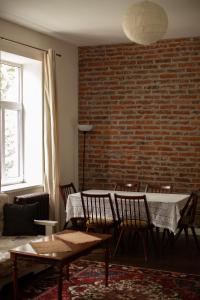 利沃夫Old Lviv Apartment的一间设有桌椅的用餐室和砖墙