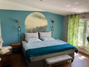 FriedrichswaldeFerienwohnungen Zur Biberburg的蓝色的卧室,配有一张壁画床