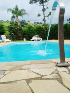 伊克斯雷玛Pousada voo livre的蓝色的游泳池,设有喷泉