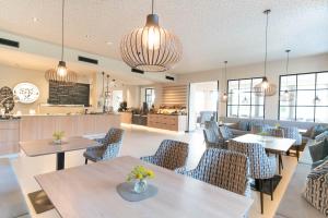 斯拉德明Apart & Suiten Hotel WEIDEN的一间带桌椅和柜台的餐厅