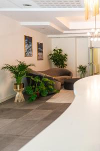 索波特Sentoza Sopot的带沙发和盆栽植物的客厅