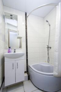 捷尔诺波尔Центр. Вулиця Руська. 2 кімнати的白色的浴室设有浴缸和水槽。