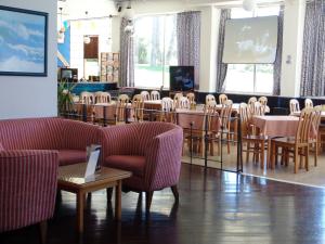 波尔蒂芒鲁阿尔酒店的配有桌椅和屏幕的房间