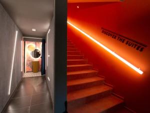里米尼Demo Hotel Design Emotion的一道红色墙壁和楼梯灯的楼梯