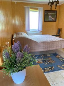 卡缅涅茨-波多利斯基Constancia的一间卧室配有一张床和一张紫色花卉桌子
