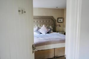 WillingtonThe Cottage的一间卧室配有带白色床单和枕头的床。